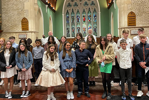 Newly confirmed children plus, back row right to left, Reverend Neal Phair and Archbishop Michael Jackson
